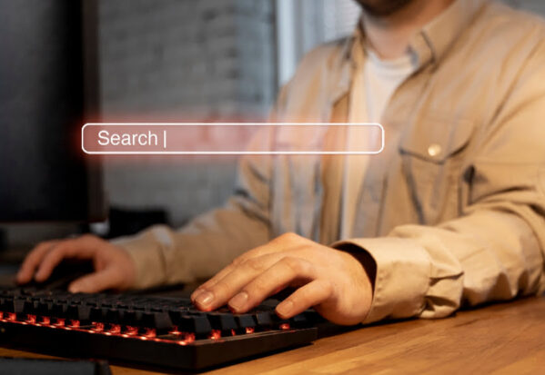 A men in front of a computer typing in Google finding an SEO optimized website